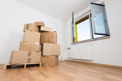 Packed household boxes and wrapped furniture ready for moving day