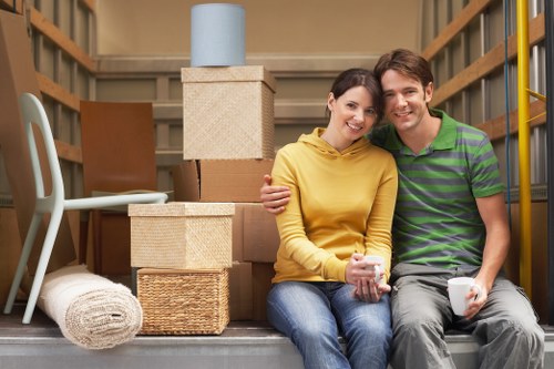 Movers carrying furniture through a Forestdale home with care